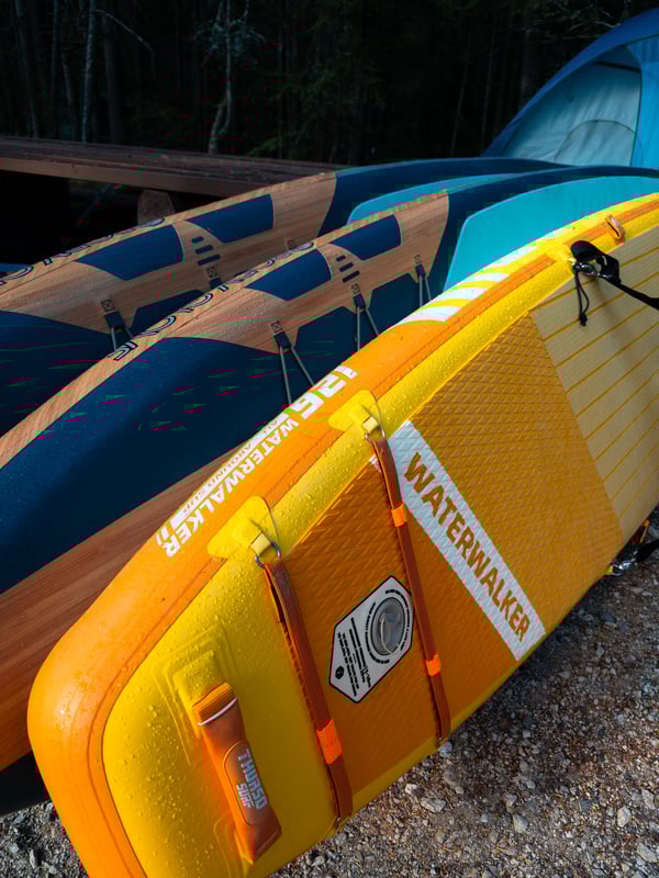 Three paddleboards leaning against each other