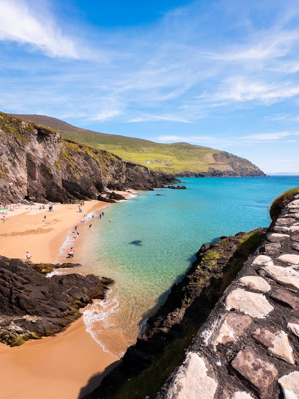 Turquoise water and white sandy beach at Coumeenoole Beach in Ireland.