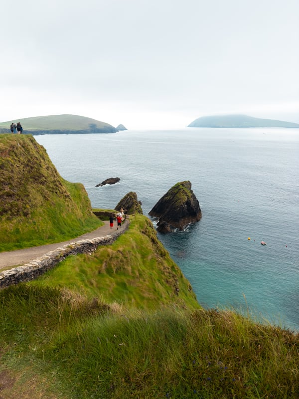 A cliffside trail at Dunquin Pier with the ocean stretching out