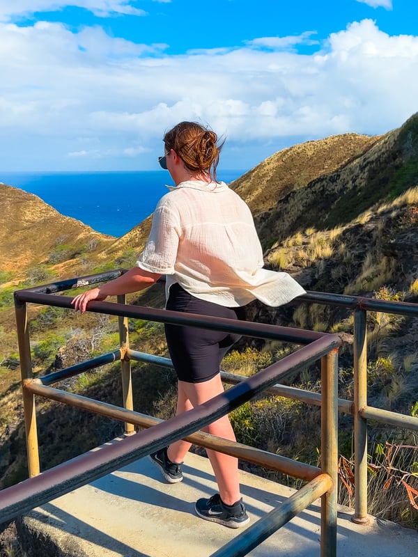 Woman walks up to a lookout halfway along the Diamond Head trail.
