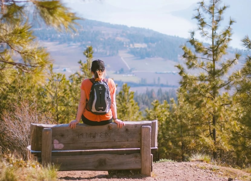 Woman sitting on the Grand Overlook bench at Spion Kop.
