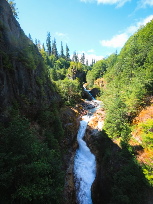 View of a cascading waterfall from the steel bridge on the Lava Canyon Trail near Mount St. Helens