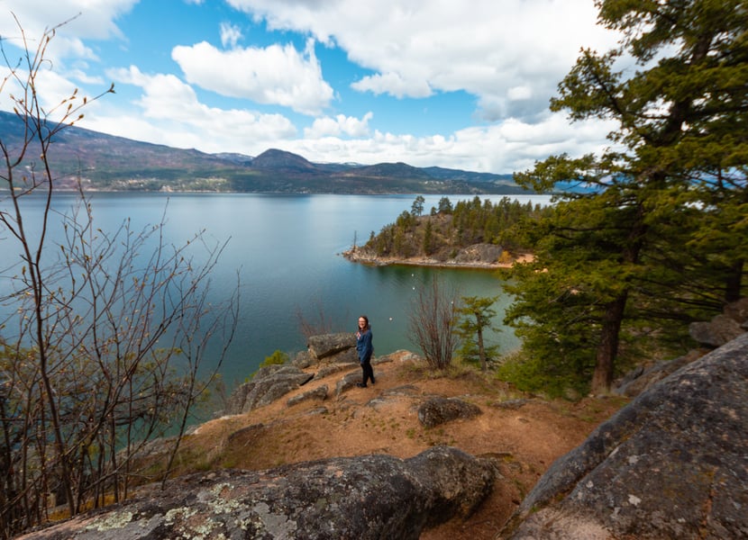 Woman stands on a bluff above the lake at Ellison