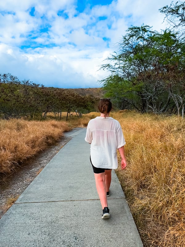 Woman walks along the flat crater bottom of Diamond Head.