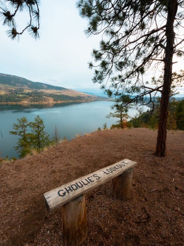 A bench with the words "Ghoulie's Lookout" overlooking Kalamalka Lake.