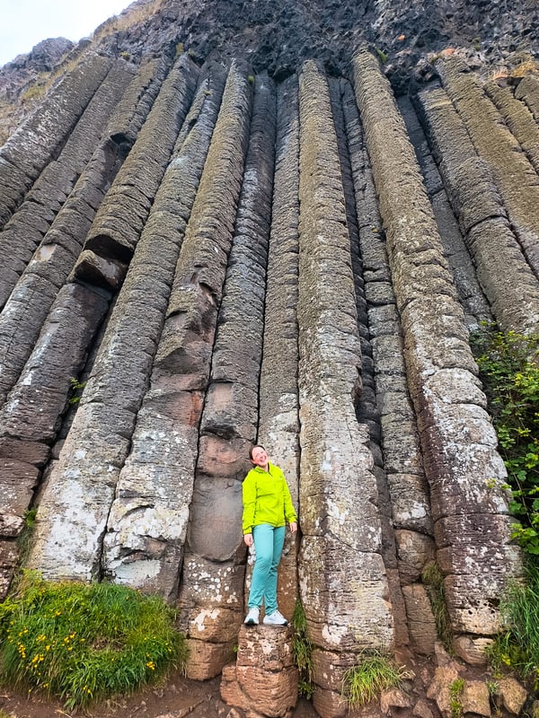 Woman in green jacket standing in front of the Organ Pipes at Giant's Causeway