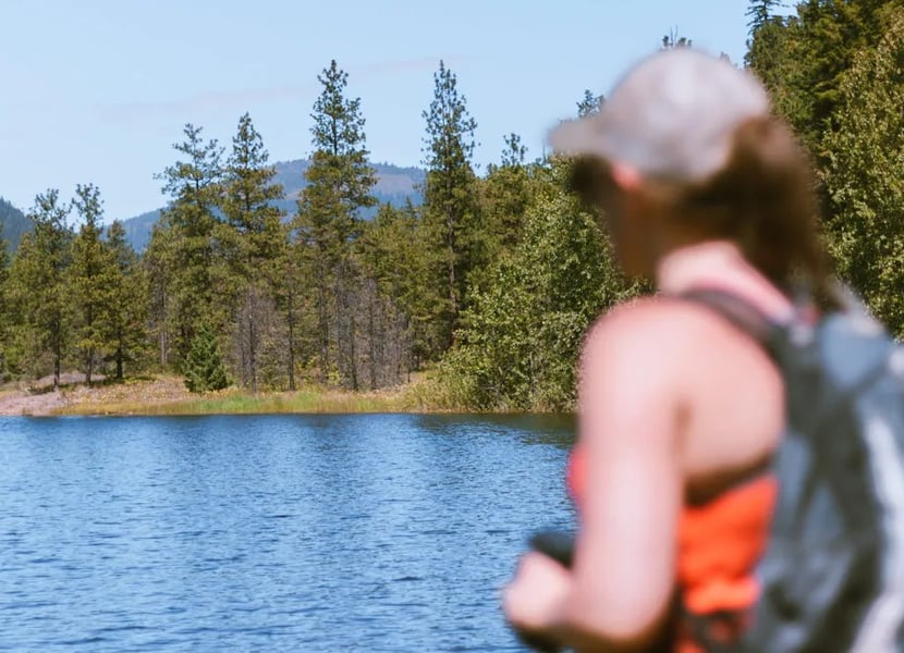 Woman looks over a blue lake