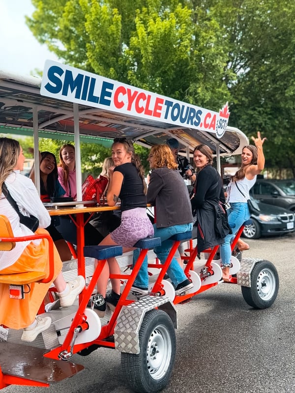 Group of women on a Smile Cycle Tour in Kelowna, which is a giant bike