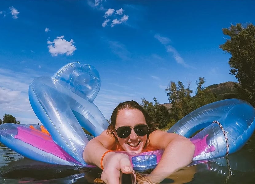Selfie of a women laying on a floatie in the Enderby River.