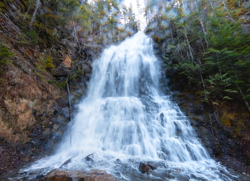 Base of Ione Falls. The lens is covered in water droplets, obscuring the photo.