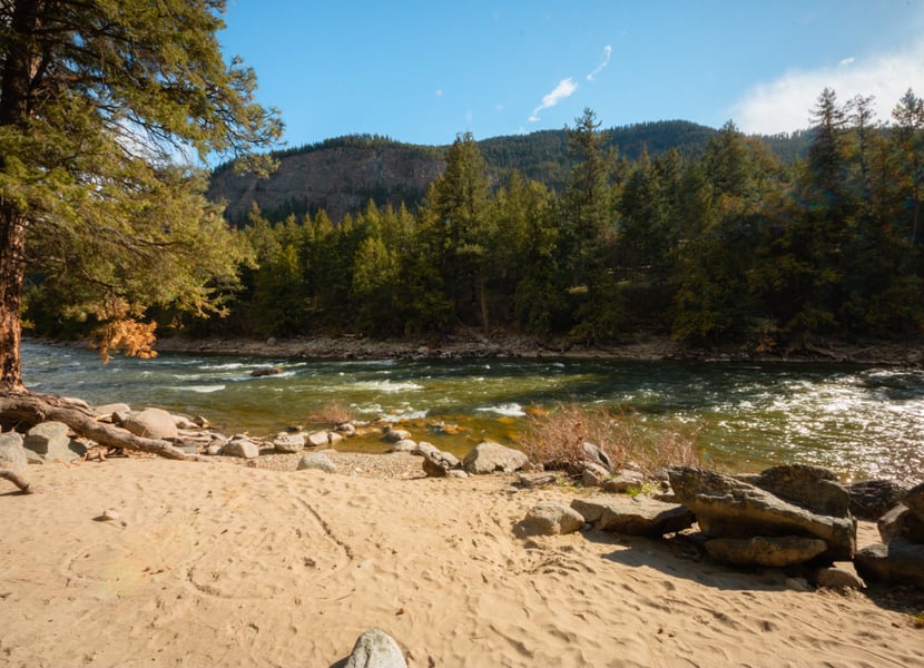 Secluded and private sandy beach on a river with a blue sky