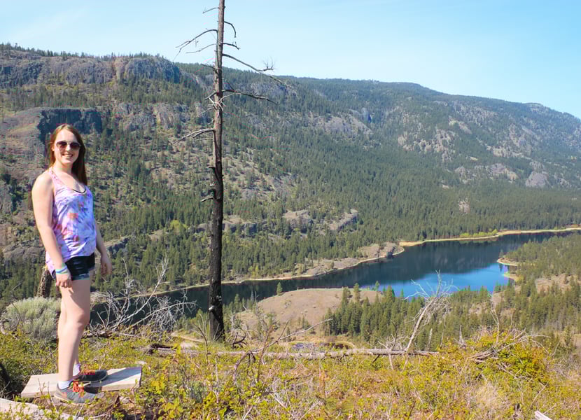 Woman stands at viewpoint above Rose Valley reservoir
