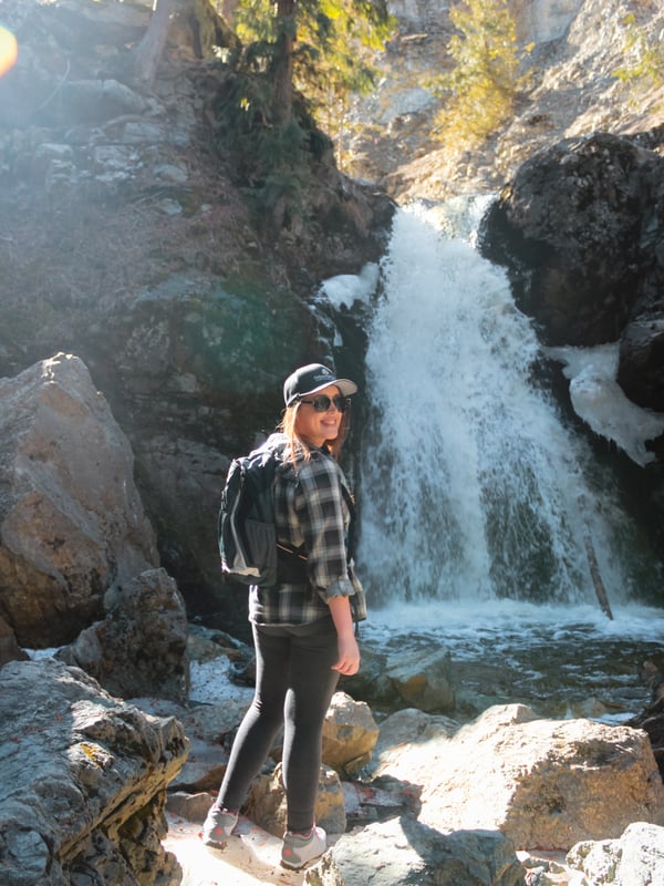 Woman stands in front of Crawford Falls in Kelowna