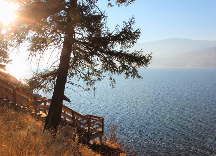 A wooden staircase leads towards Okanagan lake. Taken at sunset.
