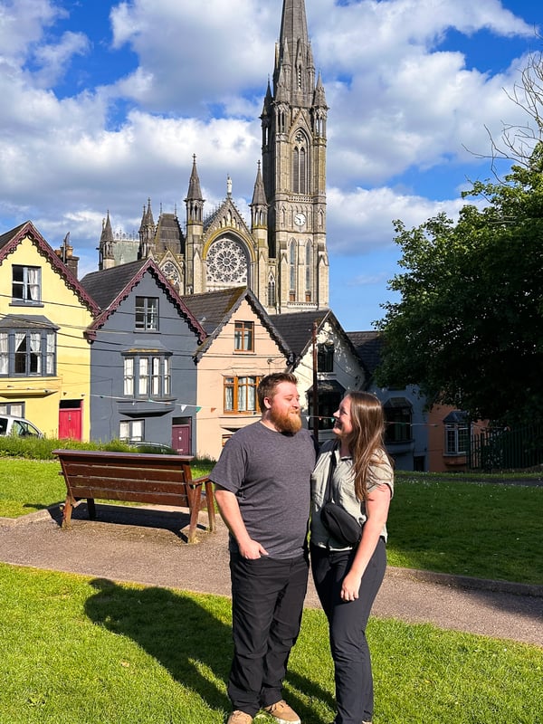Man and woman standing in the front of the Deck of Cards houses in Cork, Ireland