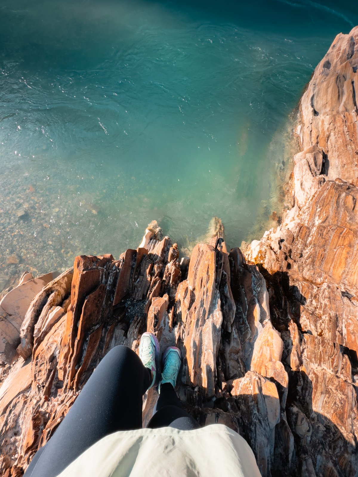 Woman stands near green water.