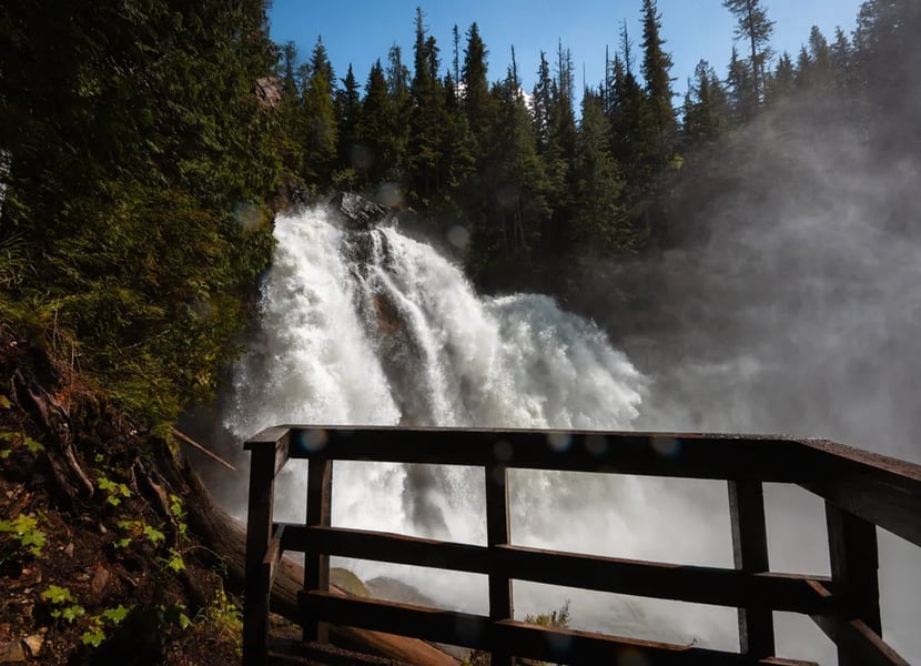 Rainbow Falls, a huge waterfall in Monashee Provincial Park in BC, roars. A viewing platform is in the foreground.