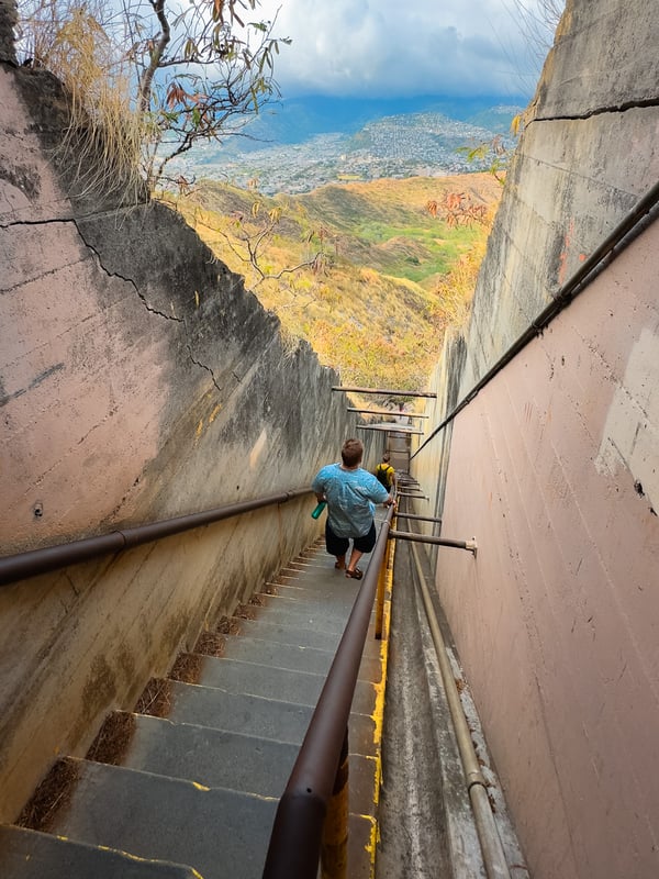 Man walks down a steep set of stairs at Diamond Head.