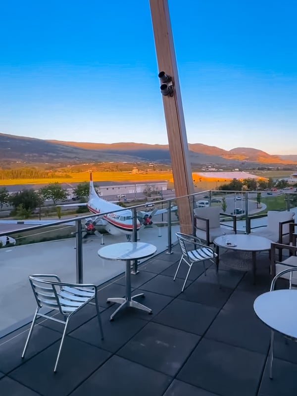 The patio at KF Centre for Excellence at sunset, with view of a plane