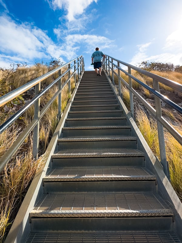 Man walks up a set of stairs.