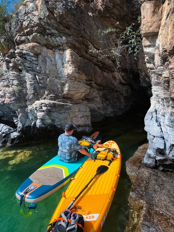 Two paddleboards at the mouth of a small cave