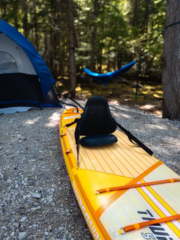 Thurso Surf paddleboard with a kayak conversion kit on it at a campground