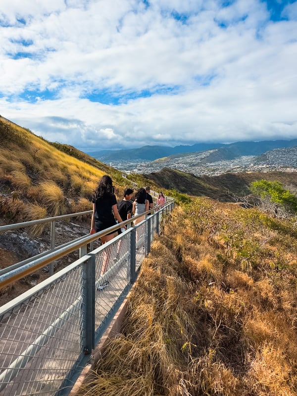 Family walks along a paved trail on the crater wall.