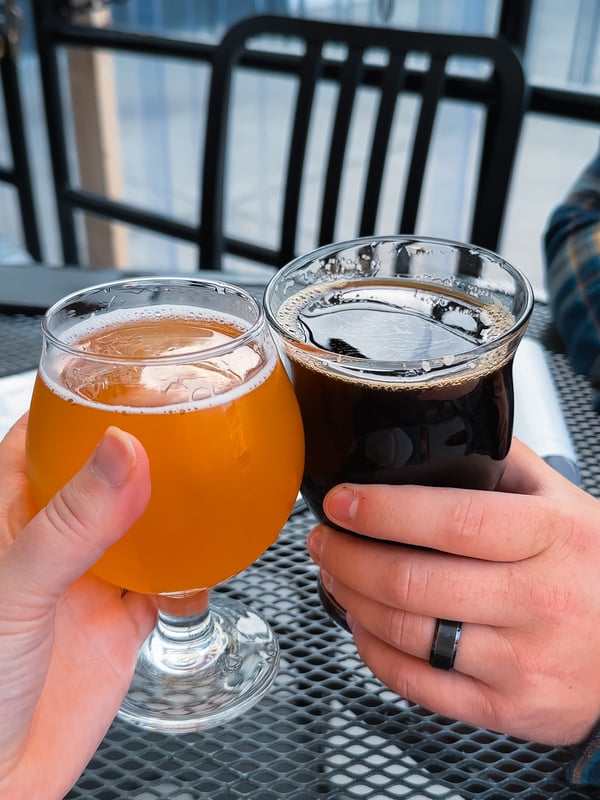Two people toast beers