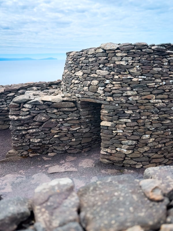 Beehive huts with the ocean in the background.