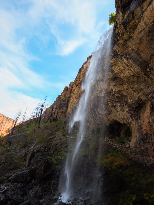 Christie Falls flows over a cliff on a sunny day