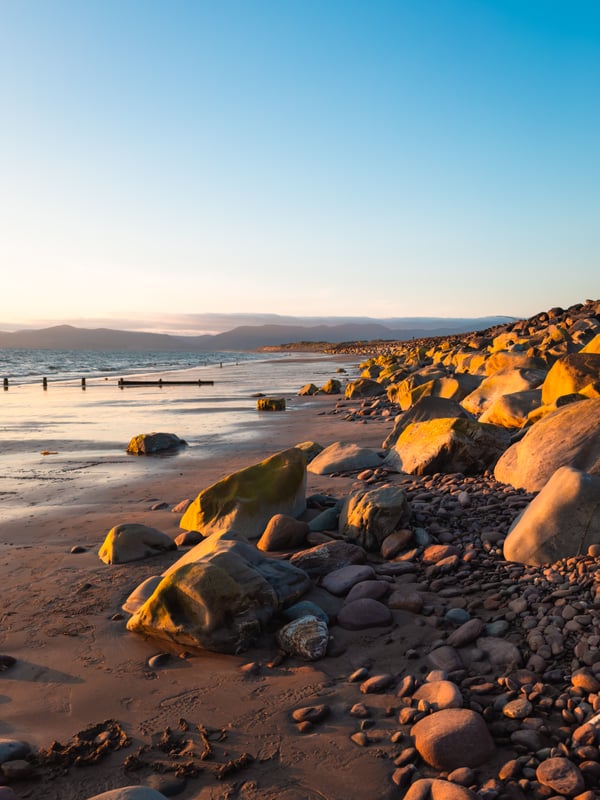 A sandy beach bathed in sunset glow.