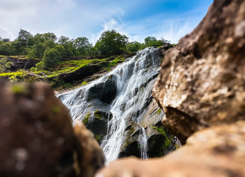 Shot up at Powerscourt Waterfall with rocks blurred out in the foreground.