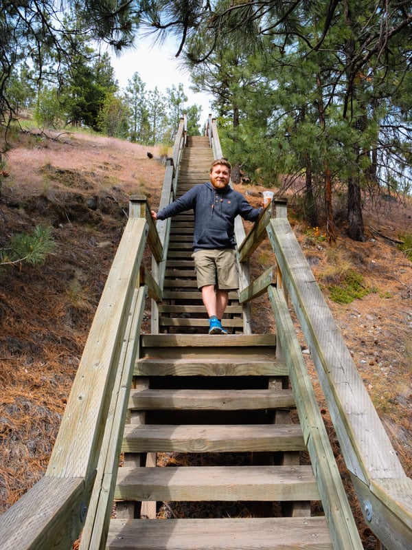 Man hiking down a wooden staircase