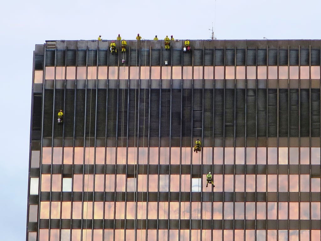 professional window cleaner cleaning house windows
