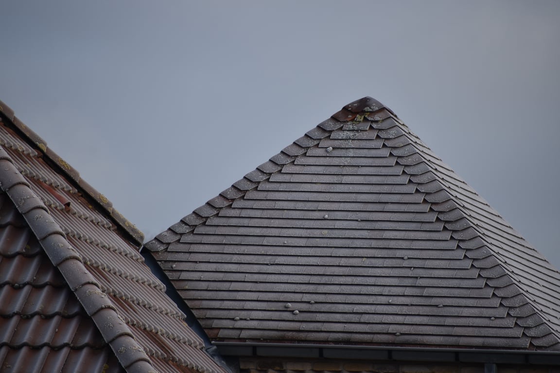 roofing contractor inspecting roof