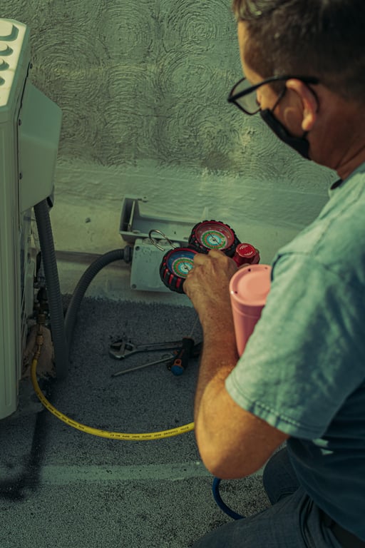 HVAC technician inspecting air conditioner