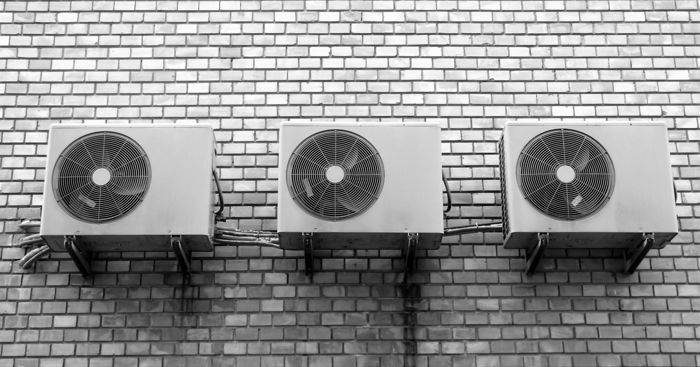HVAC technician inspecting air conditioner