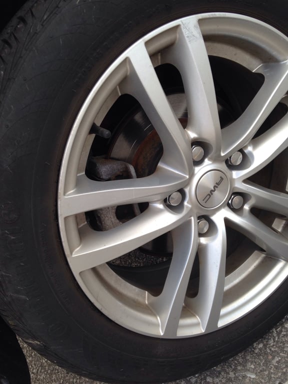 tire shop mechanic inspecting tire