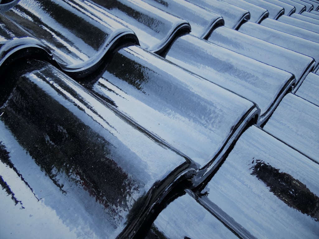 roofing contractor inspecting roof