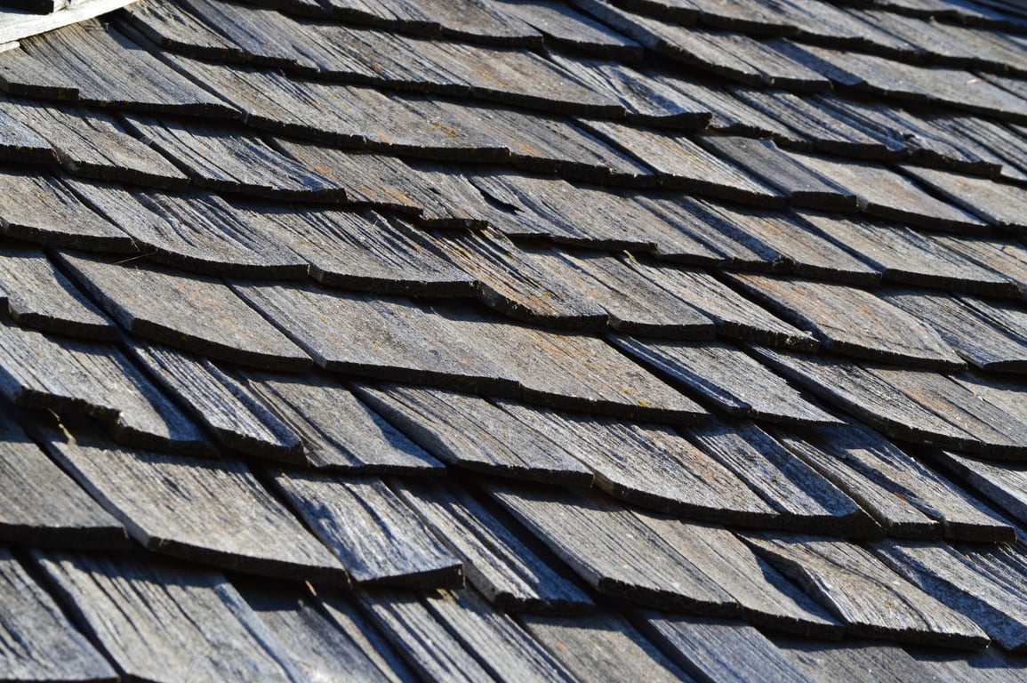 roofing contractor inspecting shingles