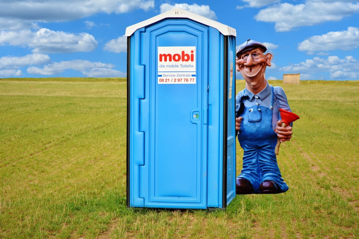 plumber installing toilet