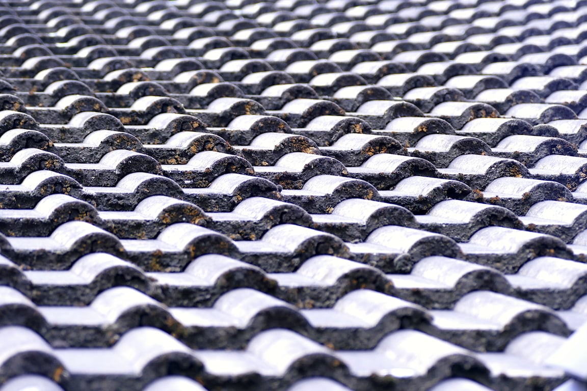 roofing contractor inspecting roof