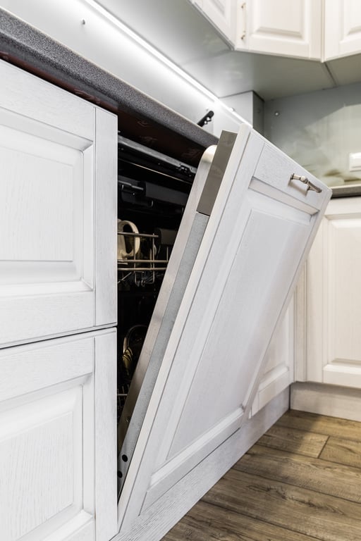 appliance repair technician inspecting dishwasher