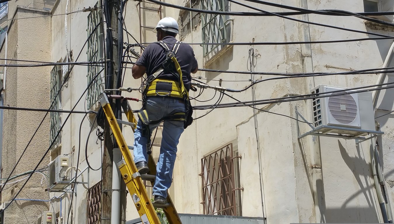 HVAC technician servicing outdoor air conditioner