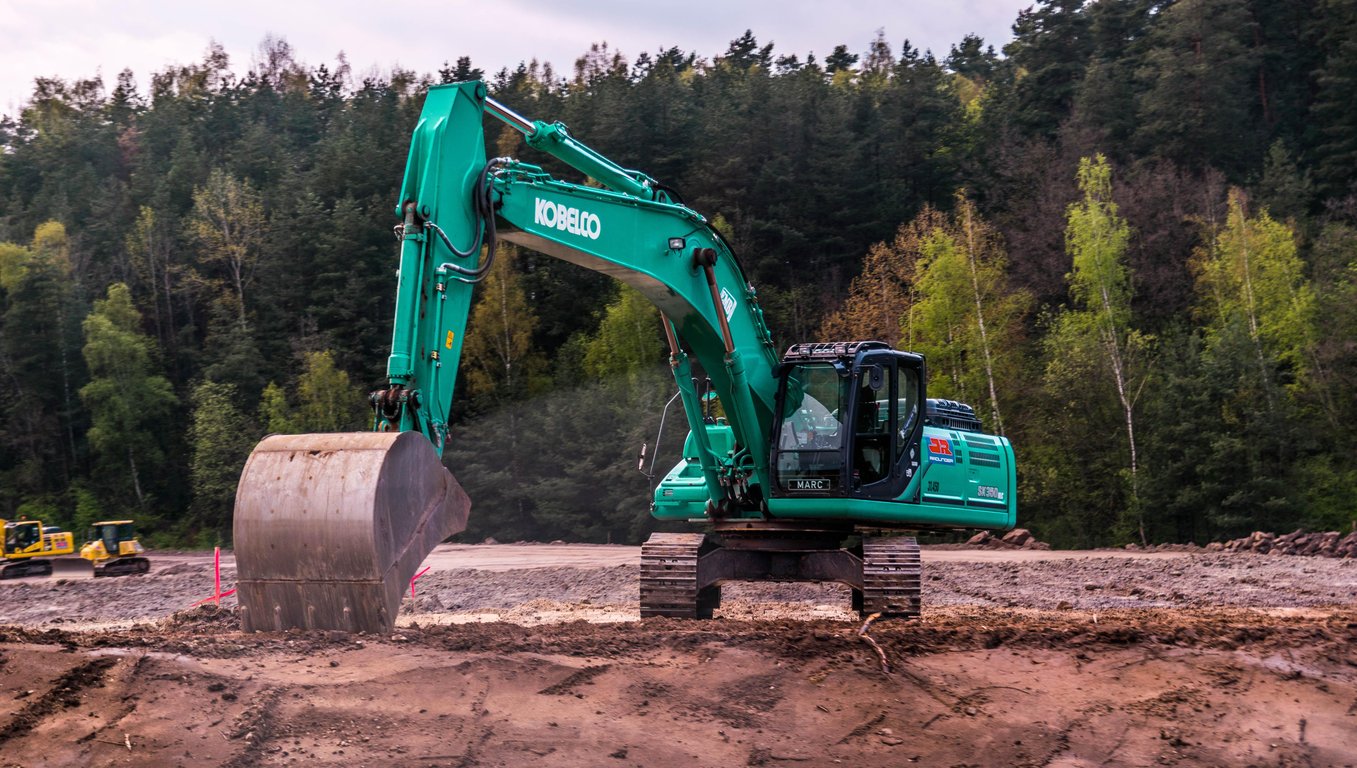 compact excavator digging trench