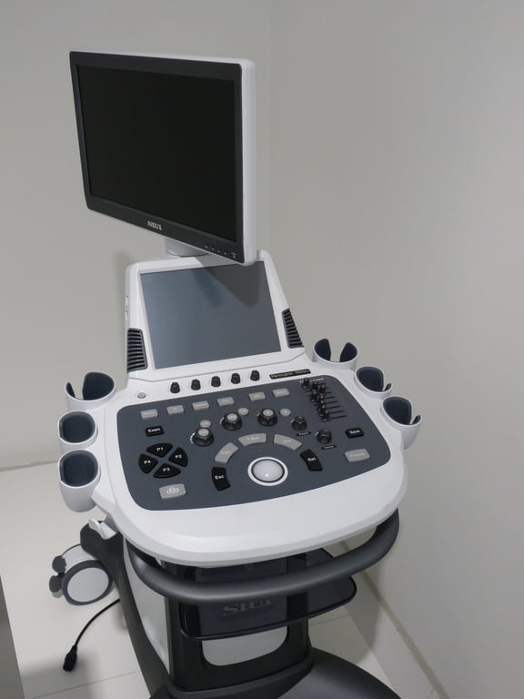 ultrasound technician scanning patient