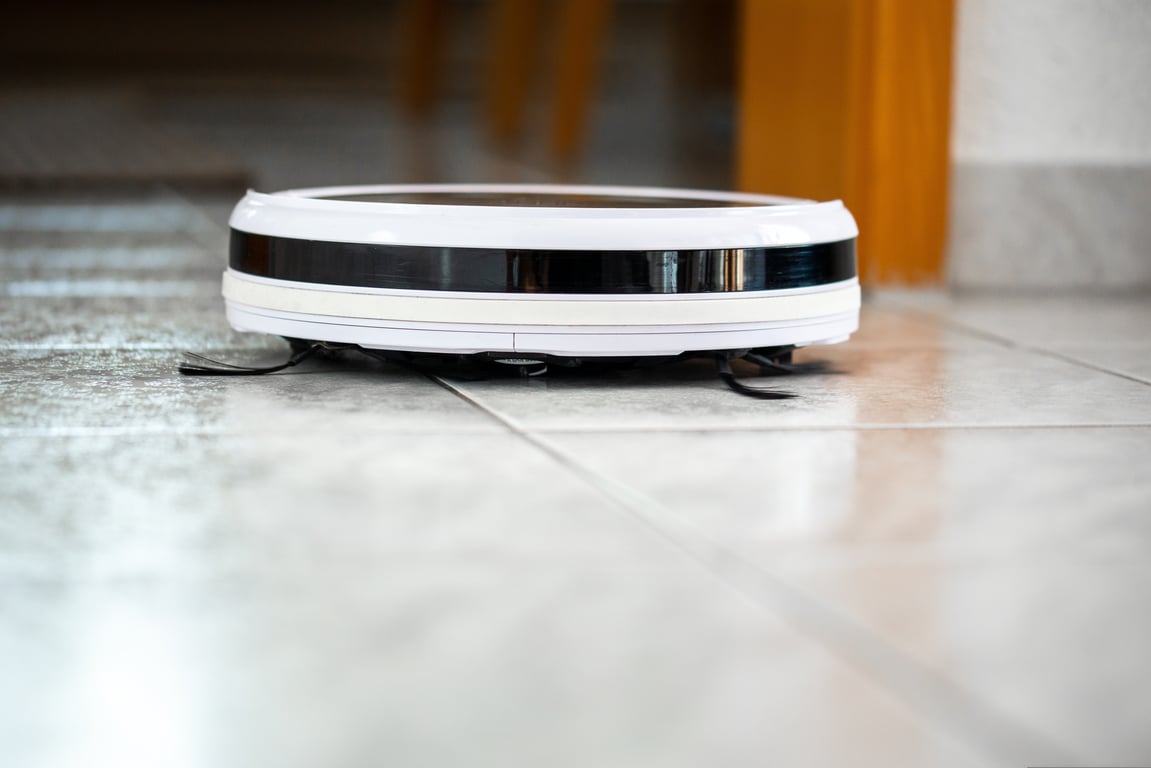 home cleaner vacuuming kitchen