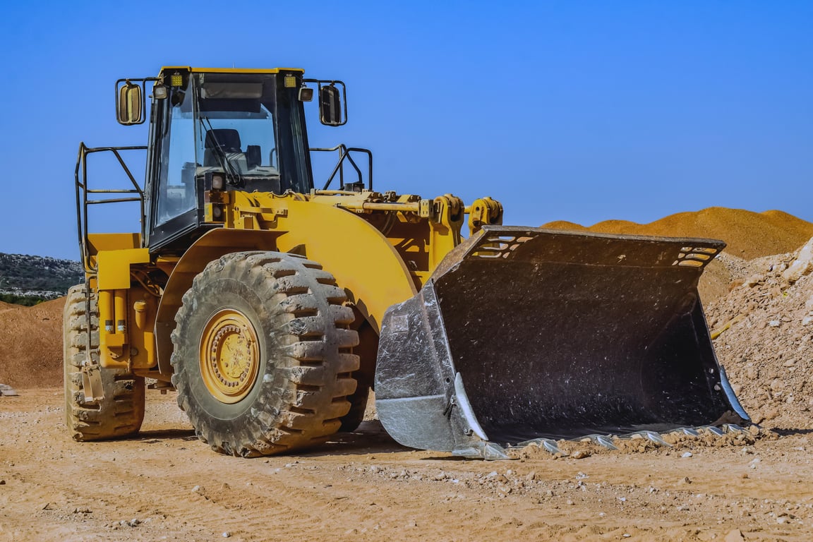 backhoe loader digging trench