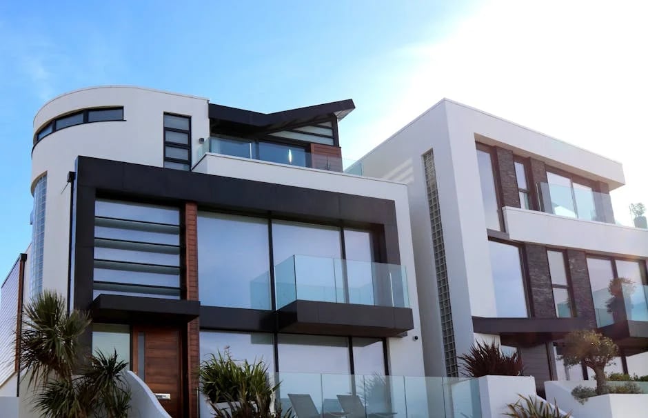 "A stunning modern mansion with a glass facade and infinity pool overlooking a coastal landscape, featured in 'Top 10 Luxury Homes You Must See in 2025'."