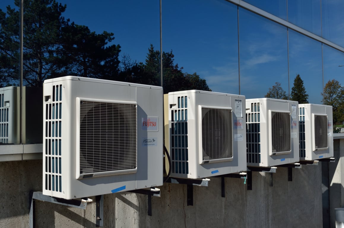 HVAC technician repairing air conditioner